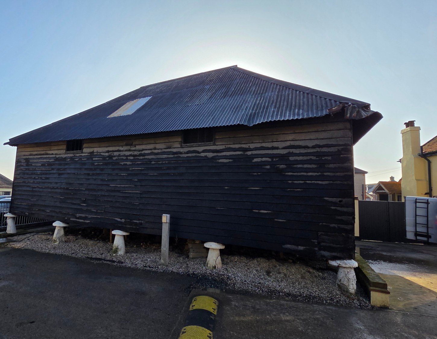 The Grade II listed eighteenth century granary at Curtis Farm, Fobbing, black weatherboarded and raised on staddle stones